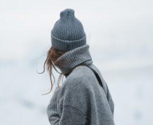 woman in grey jacket during winter facing against the camera