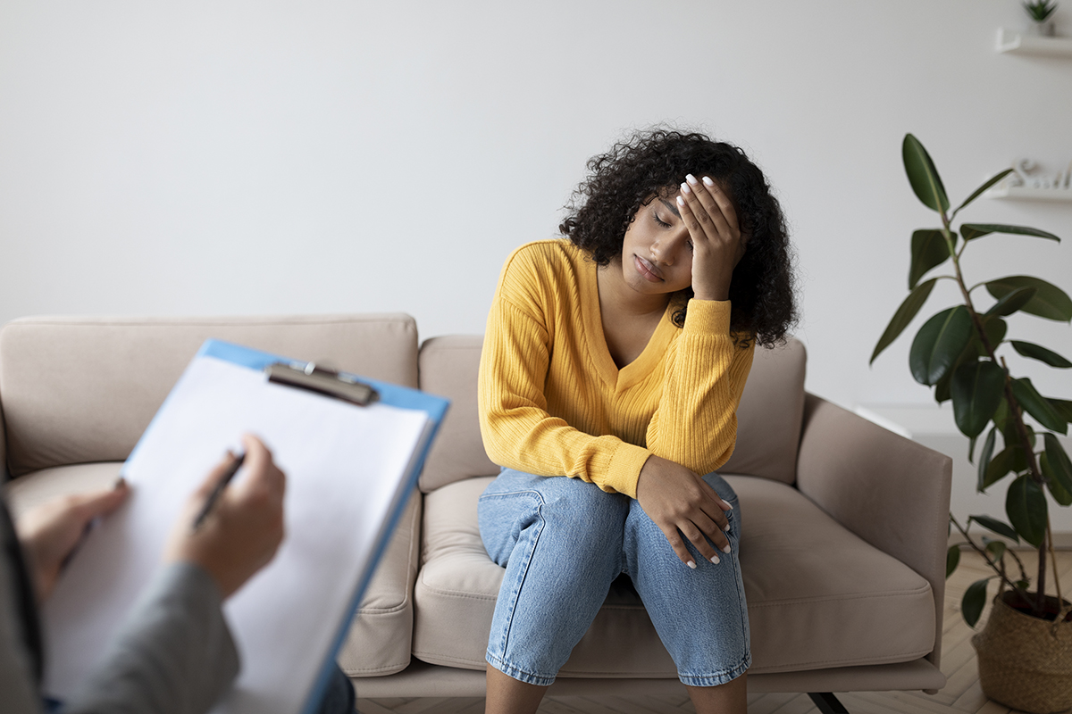 depressed woman having consultation, learn how to help someone with ptsd